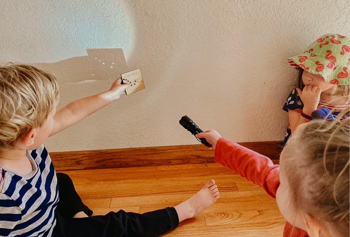 Homeschool kids using Mirus Toys Constellation Cards for exploring the history of the universe.