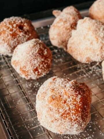 deep-fried drop biscuits with cinnamon sugar on a rack