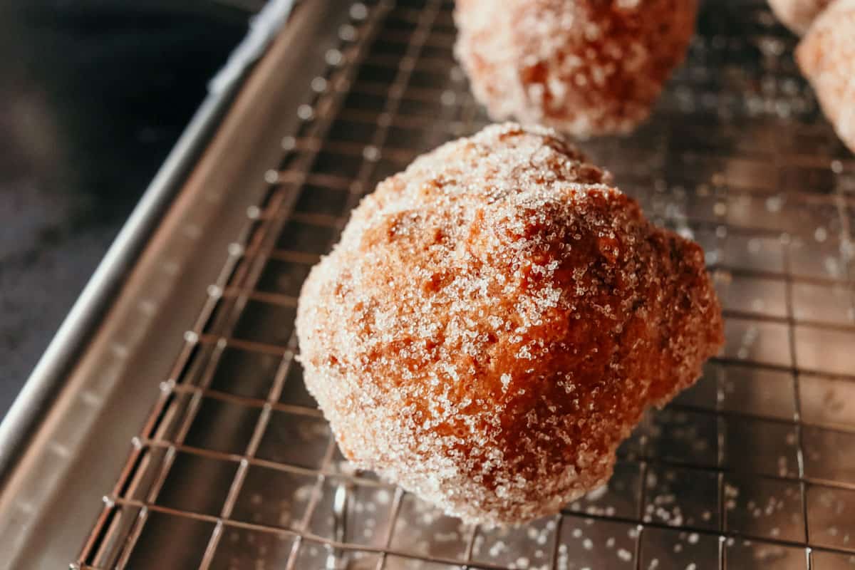 deep-fried drop biscuits with cinnamon sugar on a rack