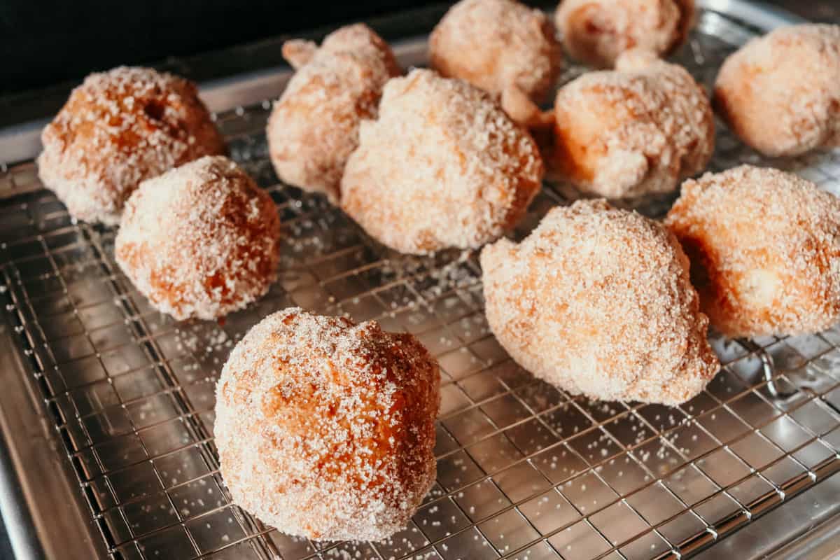 deep-fried drop biscuits with cinnamon sugar on a rack