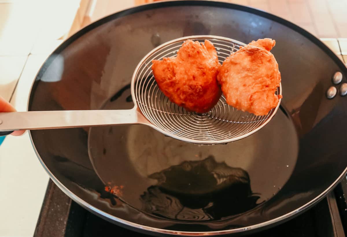 fried drop biscuits in a spider strainer