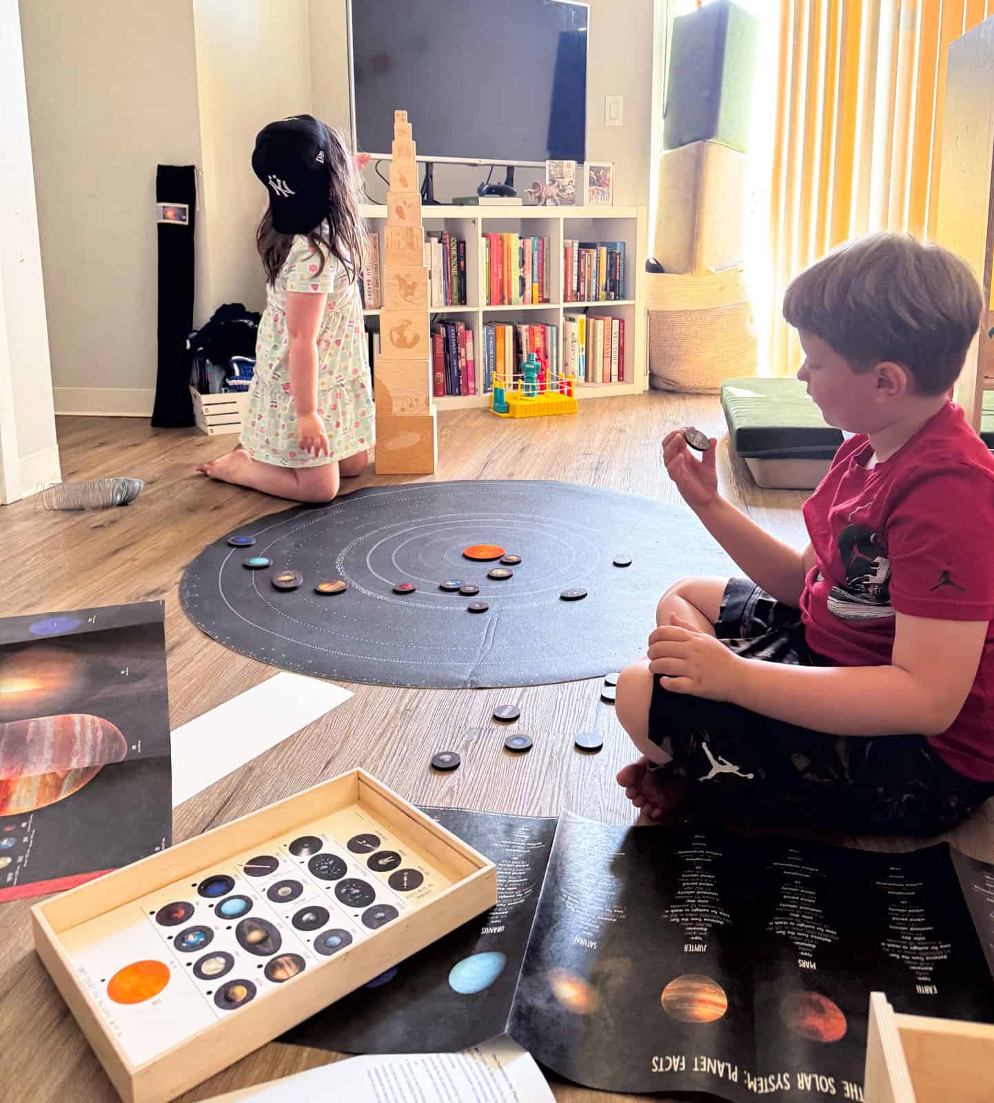 Noah and Kat are working with the solar system mat
