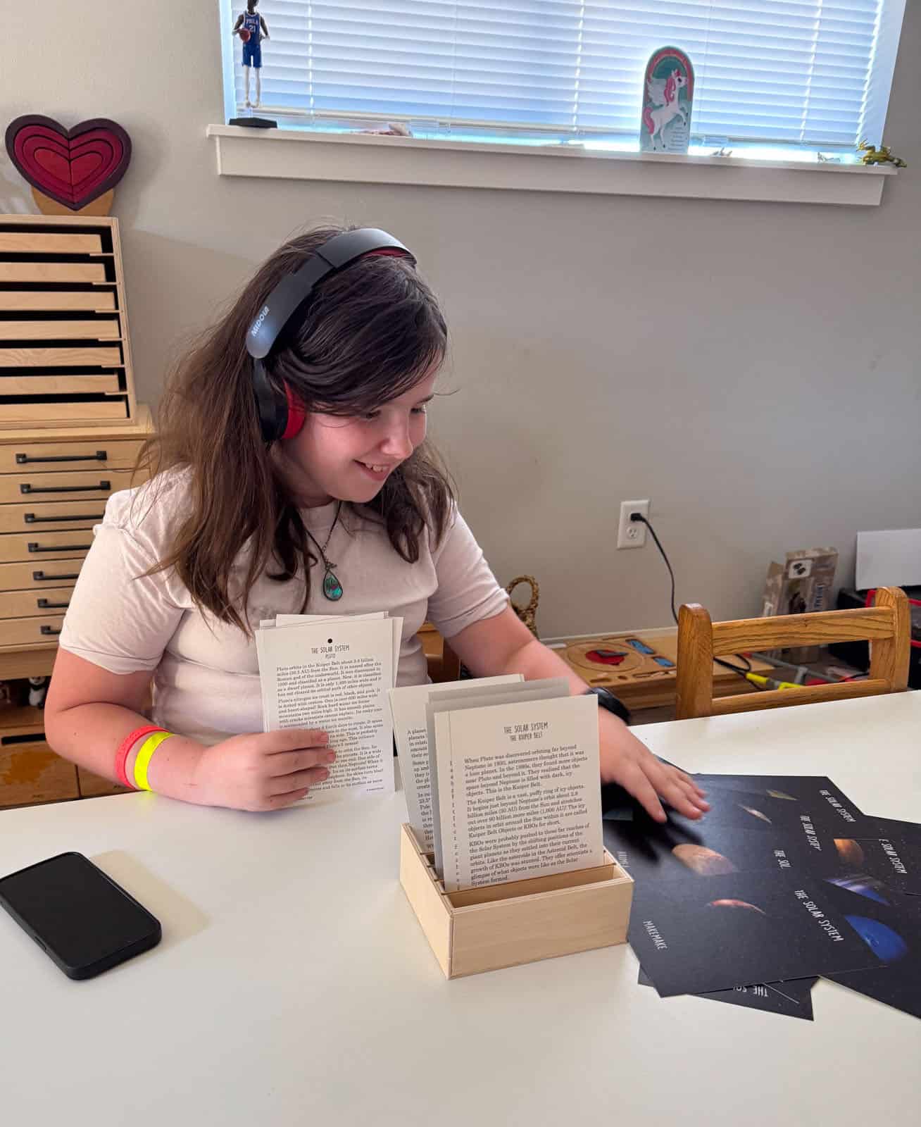 Kaia is reading the Waseca Biomes fact file cards